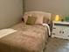 Cozy bedroom with a double bed, nightstand, and decorative accents at 1950 Summer Club Dr # 302, Oviedo, FL 32765