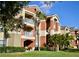 Three-story apartment building with light colored walls and balconies at 1950 Summer Club Dr # 302, Oviedo, FL 32765