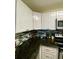 Kitchen with granite countertops and white cabinets at 1950 Summer Club Dr # 302, Oviedo, FL 32765