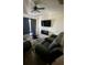 Living room with brown couches, coffee table, and large TV at 1950 Summer Club Dr # 302, Oviedo, FL 32765