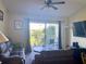 Living room with brown couches, coffee table, and sliding glass door to balcony at 1950 Summer Club Dr # 302, Oviedo, FL 32765