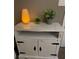 Rustic white nightstand with two doors and black hardware at 1950 Summer Club Dr # 302, Oviedo, FL 32765