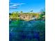 Community tennis courts and clubhouse are seen from afar at 1950 Summer Club Dr # 302, Oviedo, FL 32765