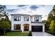 Stunning two-story home with a modern design, black accents, and a spacious driveway at 2011 University Dr, Orlando, FL 32804