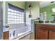 Bathroom featuring tub with window, sink, and view of the shower at 2132 Darlin Cir, Orlando, FL 32820