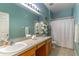 Bathroom featuring large mirror, one sink vanity, and shower with curtain at 2132 Darlin Cir, Orlando, FL 32820