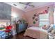Colorful bedroom with a desk, bed, and whimsical decor at 2132 Darlin Cir, Orlando, FL 32820