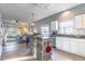 Open kitchen with stainless steel appliances, modern island, and a view into the living area at 2132 Darlin Cir, Orlando, FL 32820