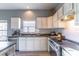 Bright kitchen featuring white cabinets, stainless steel appliances, and stylish countertops at 2132 Darlin Cir, Orlando, FL 32820