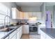 Sleek kitchen with dark countertops, white cabinets, and stainless steel appliances at 2132 Darlin Cir, Orlando, FL 32820