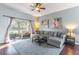 Bright living room with hardwood floors, sliding doors to the porch, and comfortable seating at 2132 Darlin Cir, Orlando, FL 32820