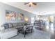 A cozy living room featuring a modern sofa, stylish decor, and an adjacent open kitchen and dining area at 2132 Darlin Cir, Orlando, FL 32820