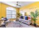 Cozy living room with yellow walls and a comfy couch at 2132 Darlin Cir, Orlando, FL 32820