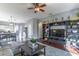 Open-concept living room with a entertainment center and a view of the adjacent kitchen and dining area at 2132 Darlin Cir, Orlando, FL 32820