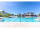Large swimming pool with lap lanes and community clubhouse in the background, under a clear blue sky at 2132 Darlin Cir, Orlando, FL 32820
