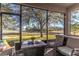 Peaceful screened porch with seating area and view of backyard at 2132 Darlin Cir, Orlando, FL 32820