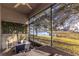 Relaxing screened porch with scenic lake view and cozy seating area at 2132 Darlin Cir, Orlando, FL 32820