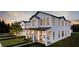 Modern white two-story house with black window frames and a metal roof at 22 W Hazel St, Orlando, FL 32804