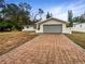 House exterior with paved driveway and landscaped yard at 224 Alpine St, Altamonte Springs, FL 32701