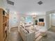 Bright living room features stylish sofas, a coffee table, and a large TV at 224 Alpine St, Altamonte Springs, FL 32701