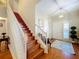 View of a wooden staircase with white railings in an entryway at 2244 N Wekiva Village Ln, Apopka, FL 32703