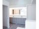 Double vanity bathroom with gray cabinets and LED mirror at 2319 Island Club Way, Orlando, FL 32822