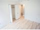 Bedroom with wood-look flooring, built-in shelving, and a double-door closet at 2319 Island Club Way, Orlando, FL 32822
