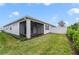 Landscaped backyard with screened patio at 3013 Cherry Blossom Loop, St Cloud, FL 34771