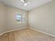 Bright bedroom with wood-look tile flooring and ceiling fan at 3013 Cherry Blossom Loop, St Cloud, FL 34771