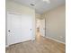 Spacious bedroom with double-door closet and wood-look tile floors at 3013 Cherry Blossom Loop, St Cloud, FL 34771