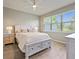 Charming bedroom with light wood furniture and large window at 3013 Cherry Blossom Loop, St Cloud, FL 34771
