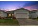 Two-car garage, landscaped walkway, and attractive curb appeal at 3013 Cherry Blossom Loop, St Cloud, FL 34771