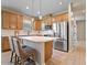 Modern kitchen with stainless steel appliances and light wood cabinets at 3013 Cherry Blossom Loop, St Cloud, FL 34771