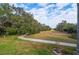 Paved pathway meanders through a tranquil landscape at 3050 Rolling Hills Ln, Apopka, FL 32712