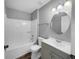 Clean bathroom with a single vanity, a shower/tub combination, and a circular mirror at 3201 S Dorchester Dr, Deltona, FL 32738