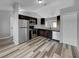 Modern kitchen with dark cabinetry, stainless steel appliances, and a breakfast bar at 3201 S Dorchester Dr, Deltona, FL 32738
