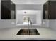 Modern kitchen with double sink and pass-through to living area at 3201 S Dorchester Dr, Deltona, FL 32738