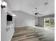 Bright living room with high ceilings and sliding glass doors leading to the backyard at 3201 S Dorchester Dr, Deltona, FL 32738