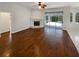 Living room with hardwood floors, fireplace, and sliding doors to the pool area at 3506 Buckingham Ct, Oviedo, FL 32765