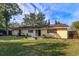 House exterior and backyard with patio and lawn at 3817 Bainbridge Ave, Orlando, FL 32839