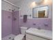 Purple tiled bathroom with shower, toilet and vanity at 3817 Bainbridge Ave, Orlando, FL 32839