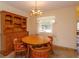 Charming dining room with round table, hutch, and wood chairs at 3817 Bainbridge Ave, Orlando, FL 32839