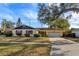 Charming ranch home with mature landscaping and a large tree in the front yard at 3817 Bainbridge Ave, Orlando, FL 32839