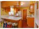 Retro kitchen with wood cabinets, tiled floor, and vintage appliances at 3817 Bainbridge Ave, Orlando, FL 32839