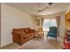 Living room with brown couch and an open view to the kitchen at 3817 Bainbridge Ave, Orlando, FL 32839