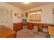 Home office with wood desk and built-in shelving at 3817 Bainbridge Ave, Orlando, FL 32839