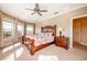 Bright bedroom with a wooden bed frame and large windows at 4230 Rex Dr, Winter Garden, FL 34787