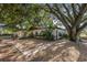 Ranch-style home with brick walkway, surrounded by mature trees at 4230 Rex Dr, Winter Garden, FL 34787