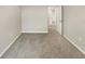 Well-lit bedroom featuring carpet and door to hallway at 4269 Desert Rose Ave, Kissimmee, FL 34746