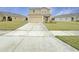 Two-story house with a beige exterior and a two-car garage at 4269 Desert Rose Ave, Kissimmee, FL 34746